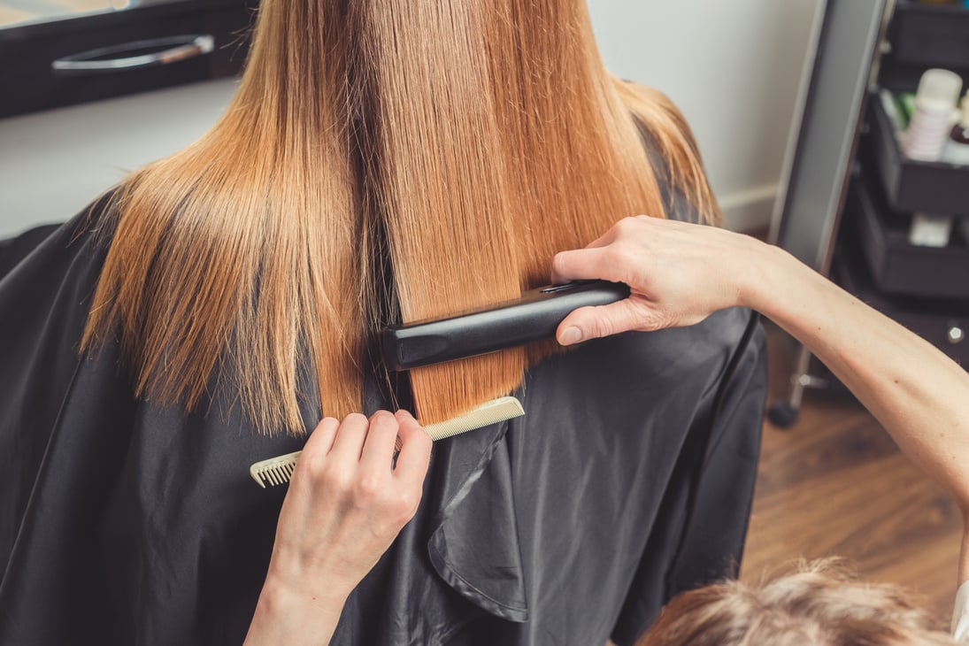 Hairdresser making a hairstyle for client